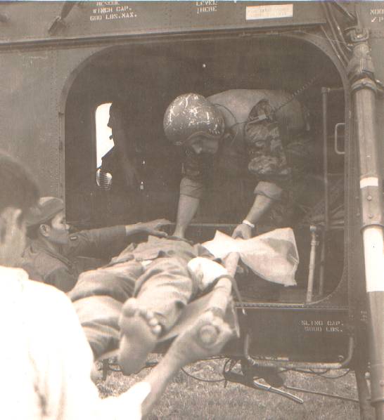 LCpl John Williams, crewchief, assisting in medical evacuation of a wounded Vietnamese soldier