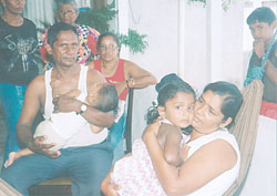 Chandroutie and David Sukhlall (Ronald's parents) with their grandchildren, Renita and Randy.