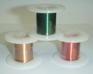 Photo of three spools of magnet wire.