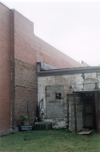 The bricks on the exterior wall next to the adjacent shop show 			the Alamo's long past and many repairs!
