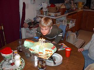 The candle-backed cake-a-saurus meets his match