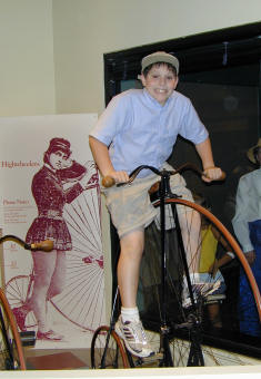 Click on Photo for Enlargement --- Noah on a Highwheeler at the Smithsonian museum of American History