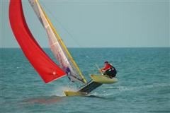 Grand entrance. Making a hotdog entrance for the photogs and cheering crowds on shore, the 8th boat to arrive.