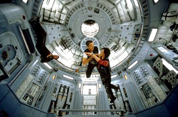 Connie Nielson and Tim Robbins dance in zero gravity as husband-wife team Terri Fisher and Woody Blake