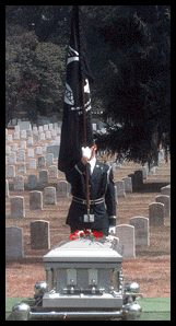 Soldier displaying the POW/MIA Flag at a burial ceremony