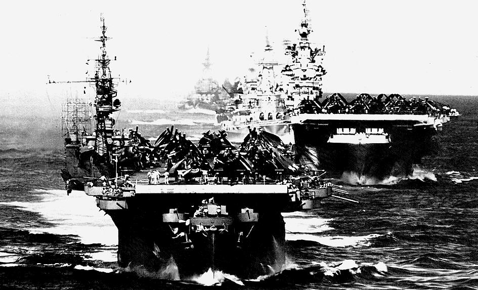 (View with screen resolution of 1024 x 768)  Ships of Task Group 38.3 entering Ulithi atoll 24 December 1944 -'light carrier 'Langley' in foreground, followed by 'Ticonderoga' and battleship 'Washington'