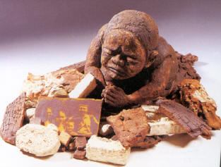 Prayer 1999-2000 A little girl luckily unharmed by the earthquake kneels inthe pile of rubble where her house once stood, looking at a family photo that survived the eqrthquake, and prays that her family can, by some miracle, be saved.