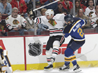 Al MacInnis shoves a Blackhawk