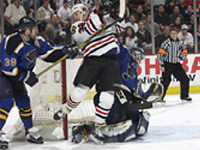 Doug Weight knocks Steve Thomas onto Johnson