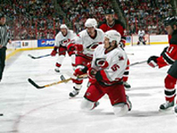 Kevyn Adams and John Madden battle over the puck