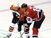 Gagne and Hossa prepare for a faceoff