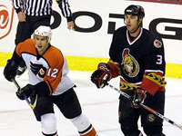 Gagne and Chara chase the puck