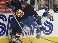 Karel Pilar is checked into the boards by New York