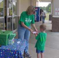 Mrs. Parker sells tickets with one of our youngest members