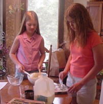 Two members make muffins