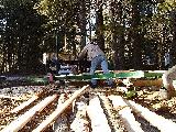 Mike using sawmill - note the bark strips...