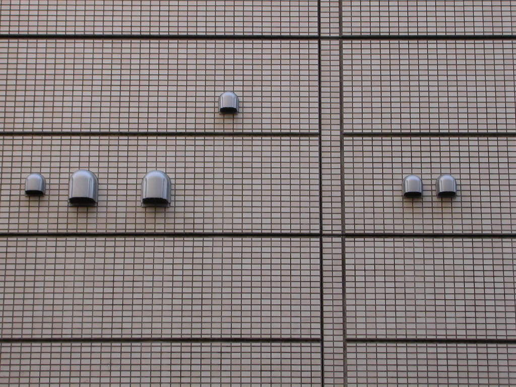 Like strange characters from an alien alphabet, these vents and their kin are scrawled all over the Tokyo streetscape.