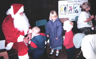 Santa Thom with a couple of the children