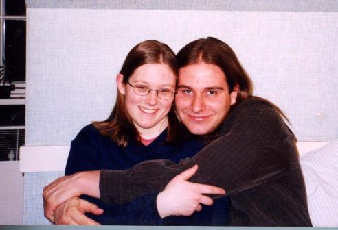 john and rachel hugging on rachel's bed