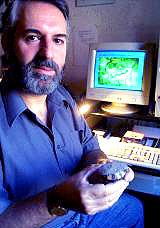 The author showing a bloodstained experimental  stone tool ready for SEM examination.