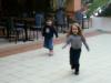My daughter Vicky and her friend playing chase at Normandie Centre.
