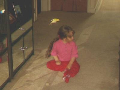 My daughter Vicky, with her canary (Sprinter) hovering above her head.
