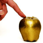 fingertip on gold apple