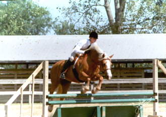 Sarah jumping the Coop