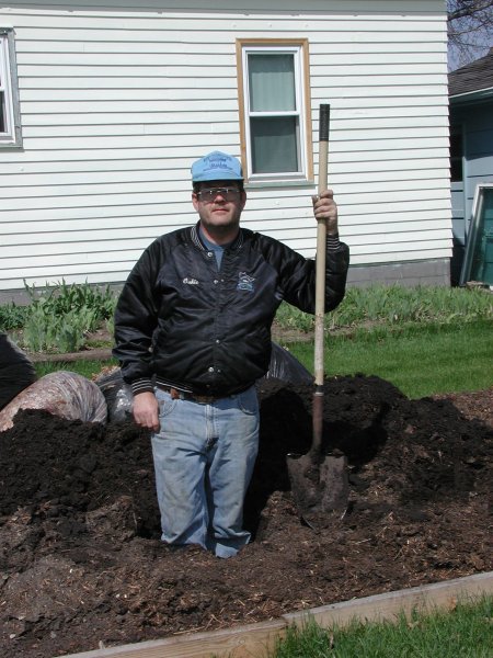 Steve in one of his holes he dug for a rosebush