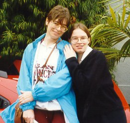 Here's a pic of me and my momma standing by a really awesome red car.