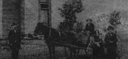 Close-up of James Stanley and wife in a wagon