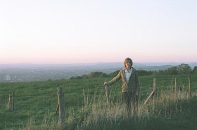 Andrea leaning on a fence in England
