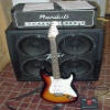 Kevin's guitar; he has updated his equipment recently.  Instead of the Peavey Envoy 110, Kevin nou has a 412 Peavey cabinet with Sheffield speakers.  He has a 120 watt Randall amp head hooked into the cab and also a Zoom 510 effects stomp box running from his guitar line to the amp head.  Kevin plays through a sunburst Fender Stratocaster with three single coil pickups.  We were sorry to see the Randall go but Kevin recently got a Peavey 60 watt amp head to play through.