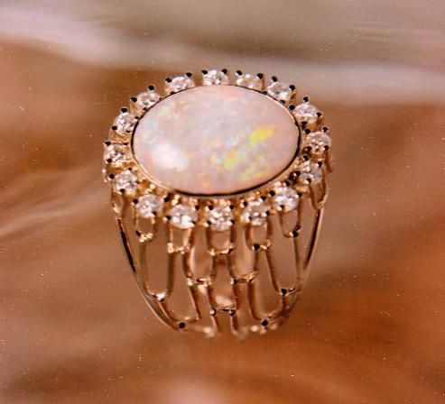 Opal gemstone bezel set in a hand fabricated gold wire ring.