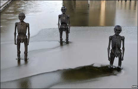 Sculptures stand in water outside the conference venue in Copenhagen, 17 December