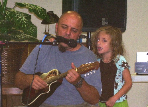Bob plays the mandolin while he has some help singing