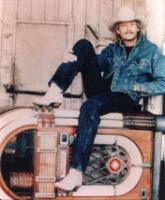 Alan Jackson sitting on jukebox