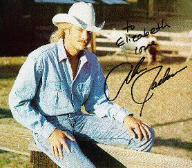 Alan Jackson sitting on a fence