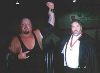 Count Grog exiting the ring raising the hand of the Beastmaster