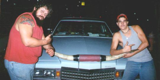 The Bull and the Mini Bull -not to be confused with his alter-ego Cinnamon- pose with the Bullmobile