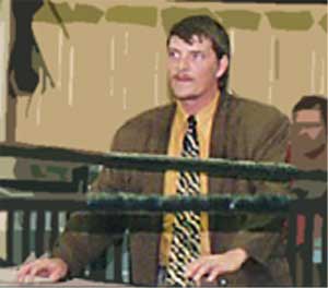 The Pastor looks on intently.