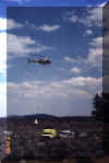 Helicopter 85-Alpha lifting off to drop off a sling load of water cubitainors on the Dry Creek Fire north of Wells in July 2002.