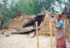 A woman eyes the destruction to her home