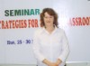 Linda Martine poses in front of the seminar banner