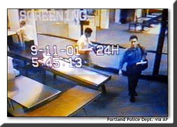 Two men, indentified by authorities as suspected hijackers Mohammed Atta, right, and Abdulaziz Alomari, center, pass through airport security on Sept. 11 at Portland International Jetport in this surveillance tape photo.