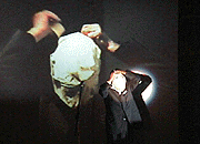 Channing Hansen (Beck's brother) and his grandfather (on screen) wrapping their heads with masking tape at a 'Happening', at the Roxy, NYC, Sept. 17, 1998