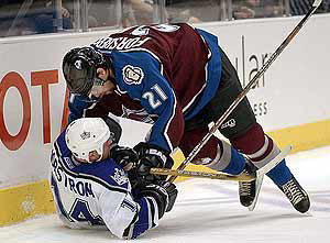 Peter Forsberg crashes against the boards with the Kings' Mattias Norstrom.
AP . La 3,Avs 1,
Photo by AP. http://www.dailycamera.com