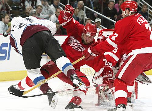 Air Forsberg. The Avs' Peter Forsberg, left, is sent flying after colliding with the Red Wings' Darren McCarty, middle. (Jeff Vinnick/Getty Images, May 29, 2002)