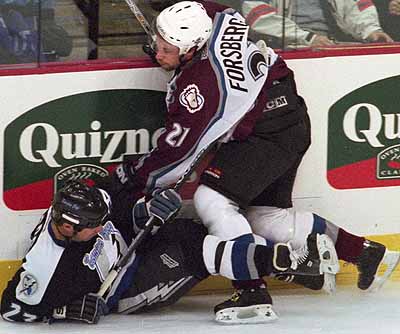 Colorado Avalanche center Peter Forsberg (21) tangles with Tampa Bay Lightning defenseman Petr Svoboda (23) during the first period in Denver, Monday, Dec. 11, 2000. (Photo/Jack Dempsey)