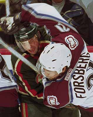 Colorado Avalanche center Peter Forsberg (21) and Minnesota Wild's Scott Pellerin (33) fight for position during the third period at the Pepsi Center in Denver Tuesday, Nov. 7, 2000. The Avalanche beat the Wild 2-0. ( Photo/Jack Dempsey)